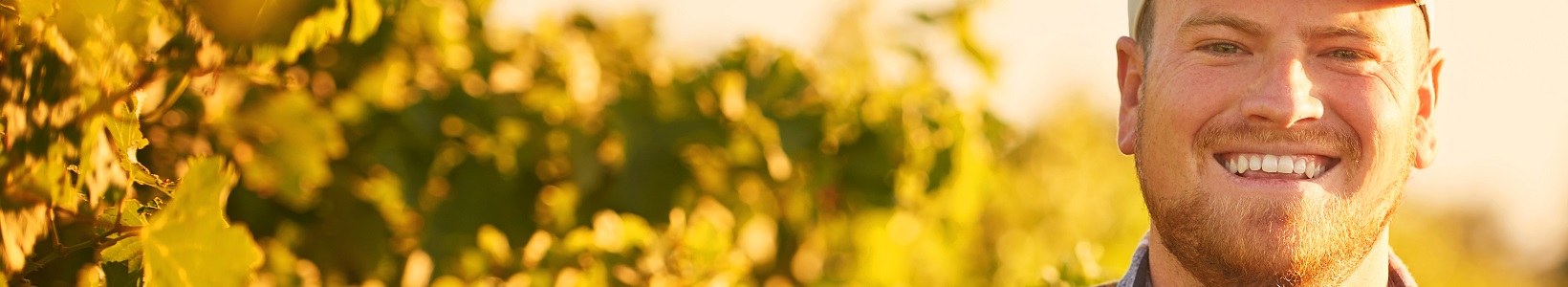 Farming is in my blood. Portrait of a happy farmer posing with his arms crossed in a vineyard.